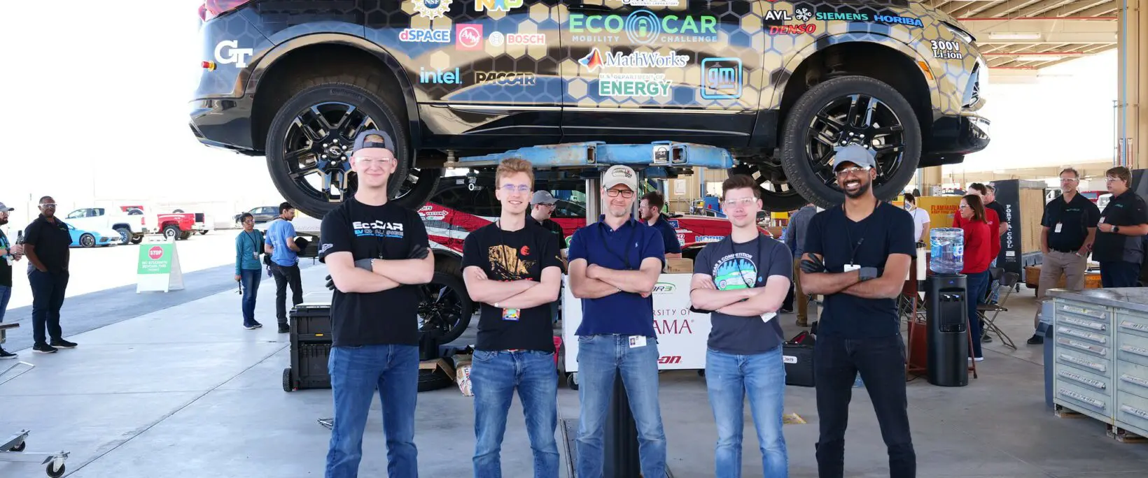 Students standing in front of car