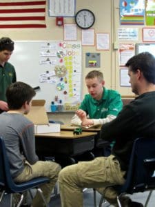 Engineering Manager, Clinton Knackstedt, explains regenerative braking to one of the students at the Timnath Elementary STEM Festival.