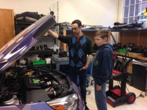 Controls Co-lead Nate Steinbock shows Seattle 7th-grader the UW EcoCAR 2